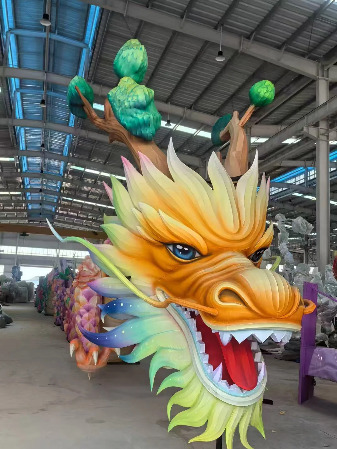 Close view of a colorful dragon head lantern during workshop fabrication