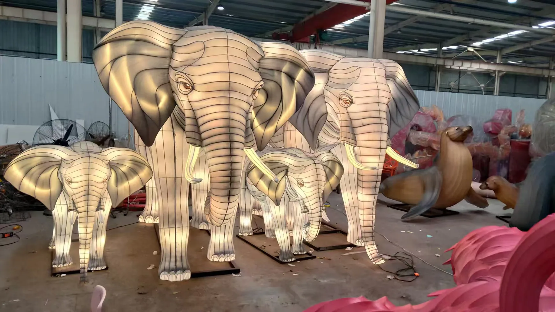 Illuminated elephant family lanterns in the Shilong workshop