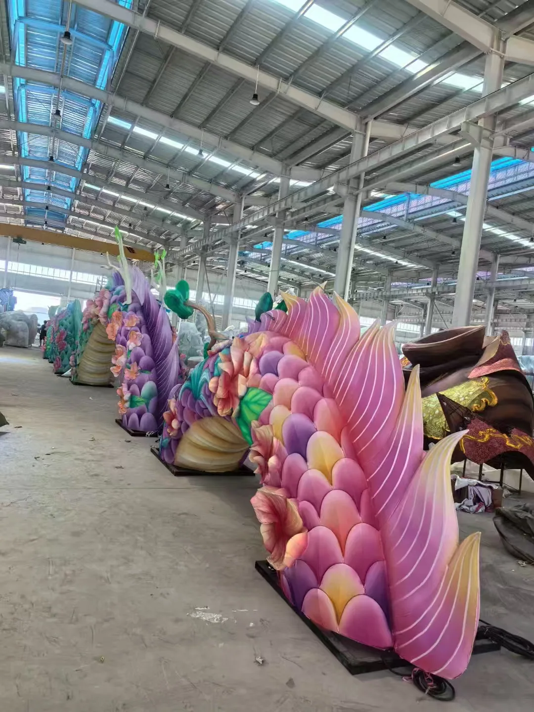 Colorful floral dragon body sections inside the workshop
