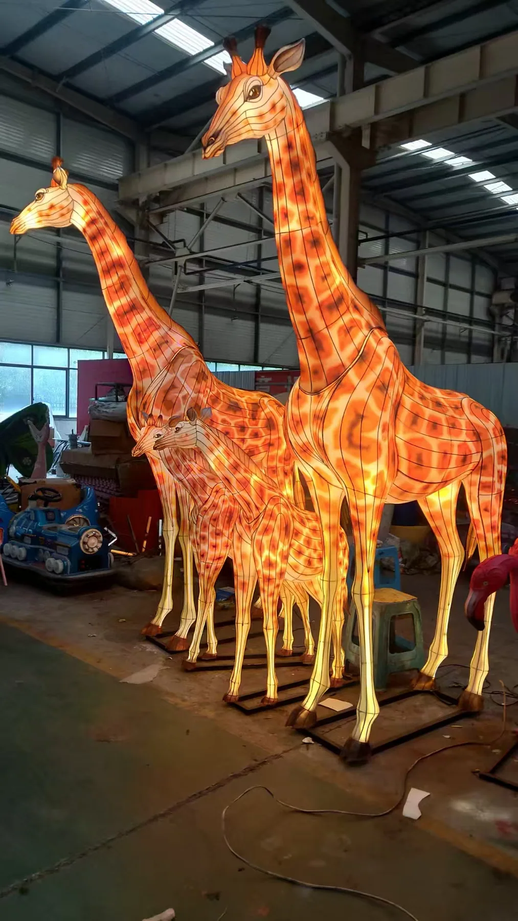 Illuminated giraffe family lanterns tested in the workshop