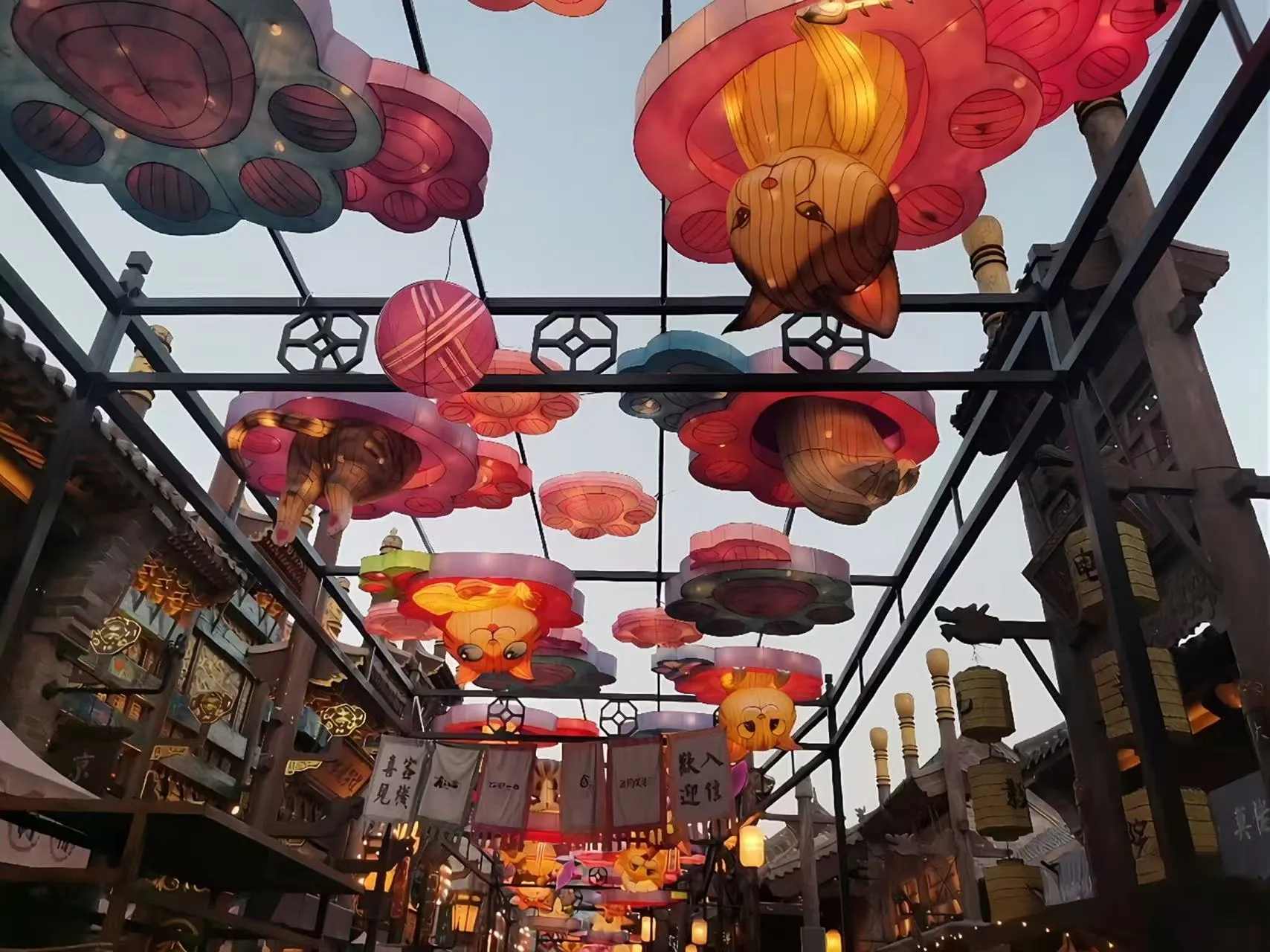 Overhead cat lantern canopy above a themed street route