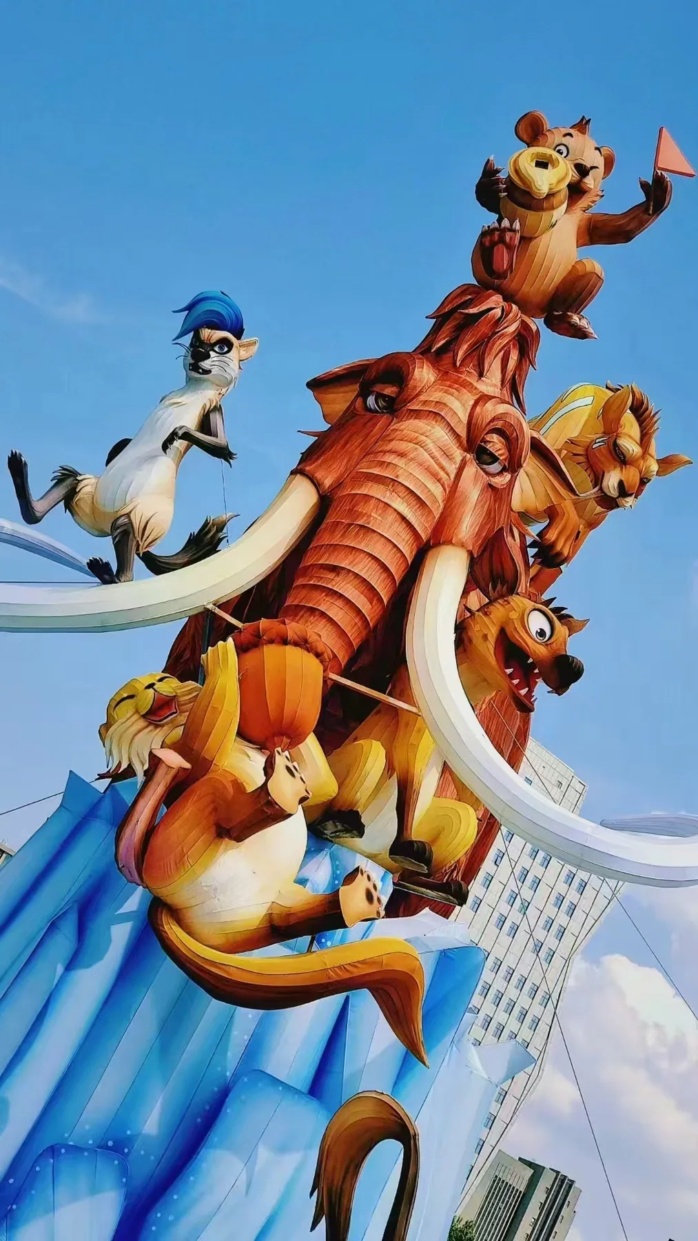 Monumental animal lantern sculpture installed against the Montreal skyline