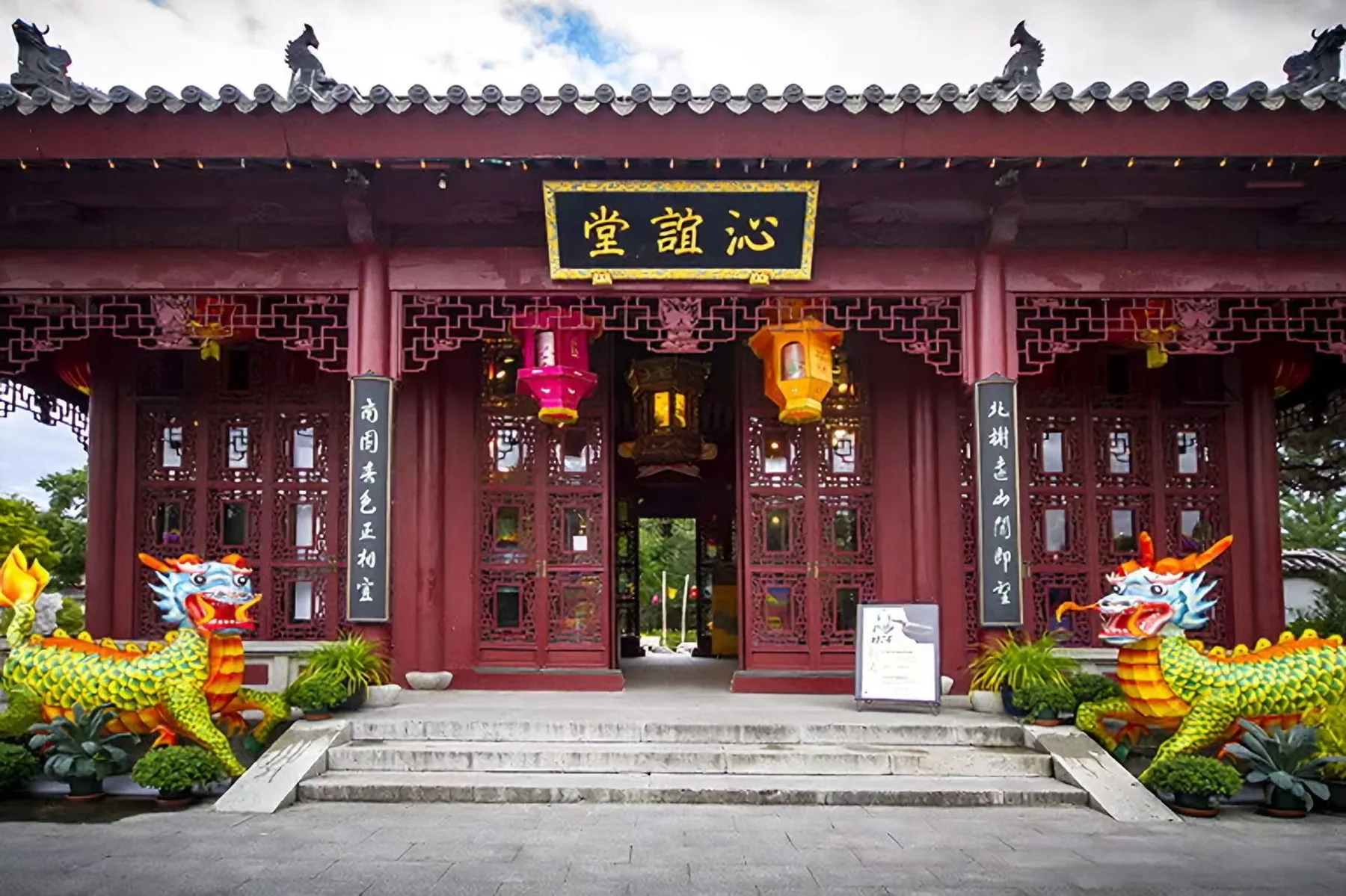 Dragon lanterns installed beside traditional garden architecture in Montreal