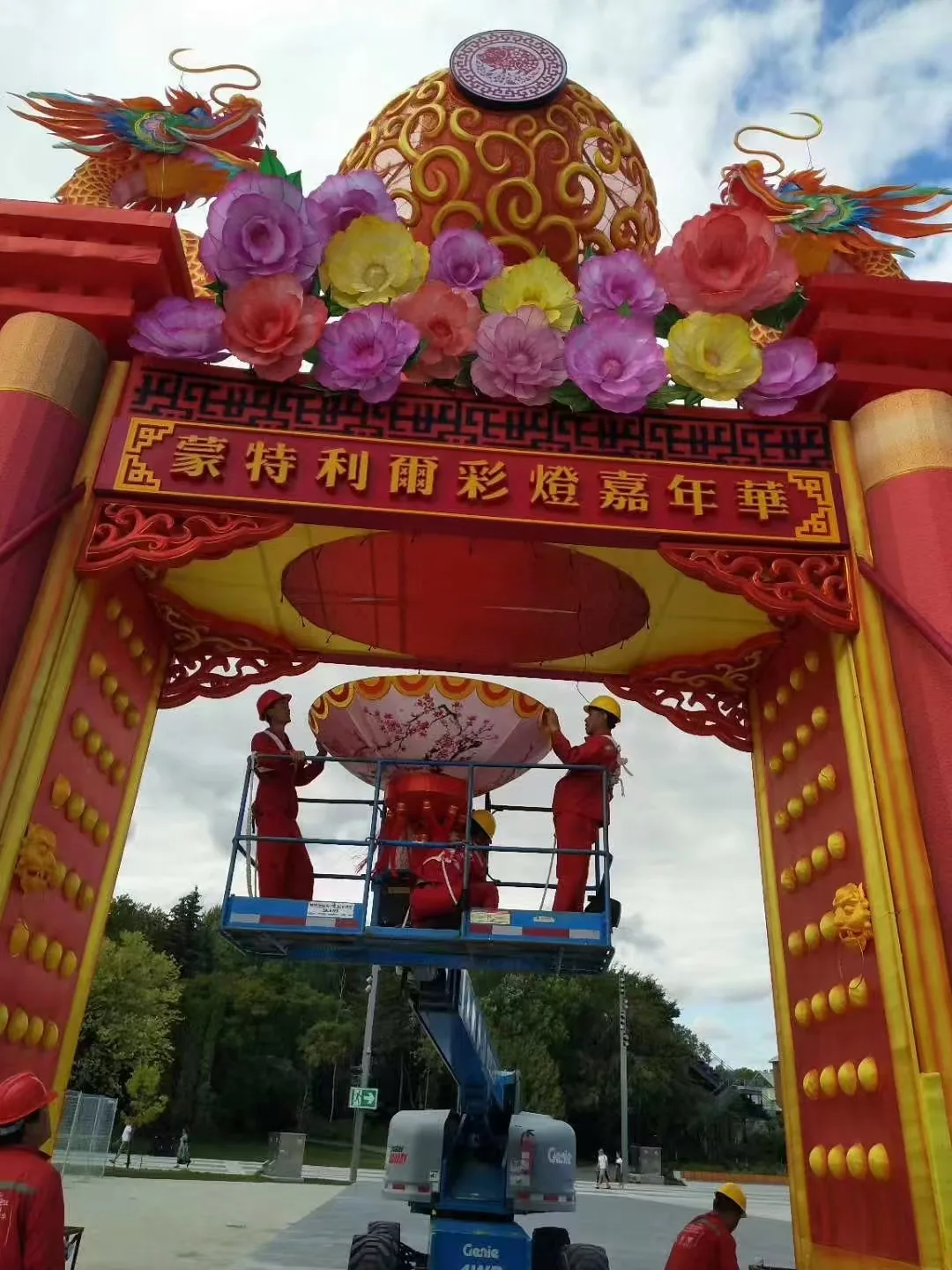 Crew using a lift to install the Montreal lantern carnival entrance