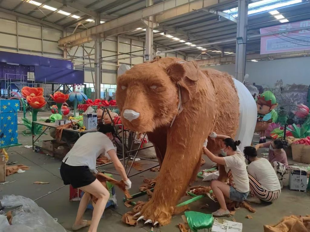 Artisans hand-crafting a giant bear lantern in the Shilong workshop