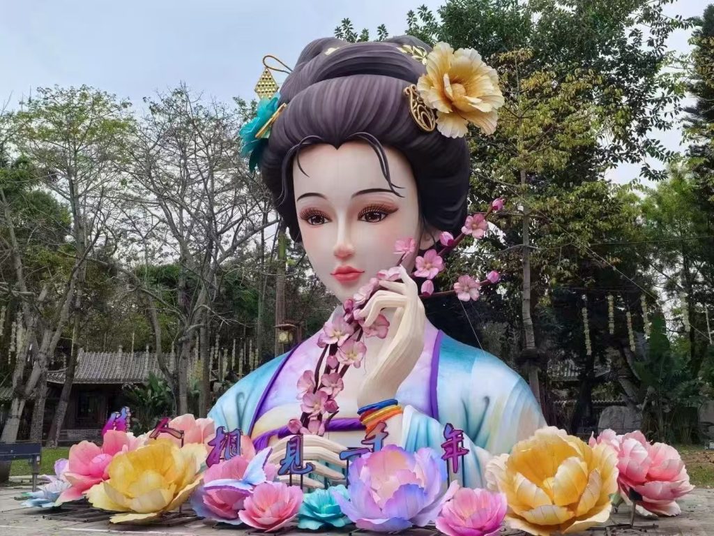 Hand-painted lady lantern surrounded by peony lanterns in a park